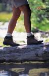 photo of woman's legs wearing shorts and hiking boots